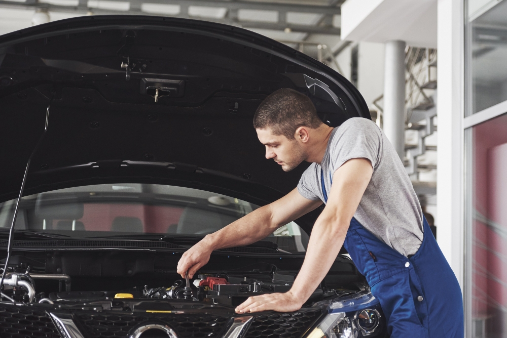 Image showing a mechanic inspecting a car engine.