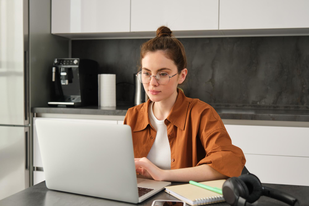 Woman using a laptop at a desk