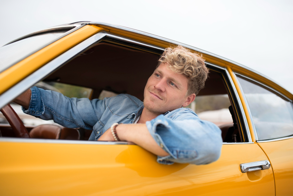 A young man driving a car