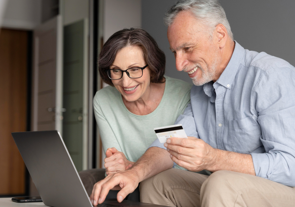A couple making a payment using a laptop.