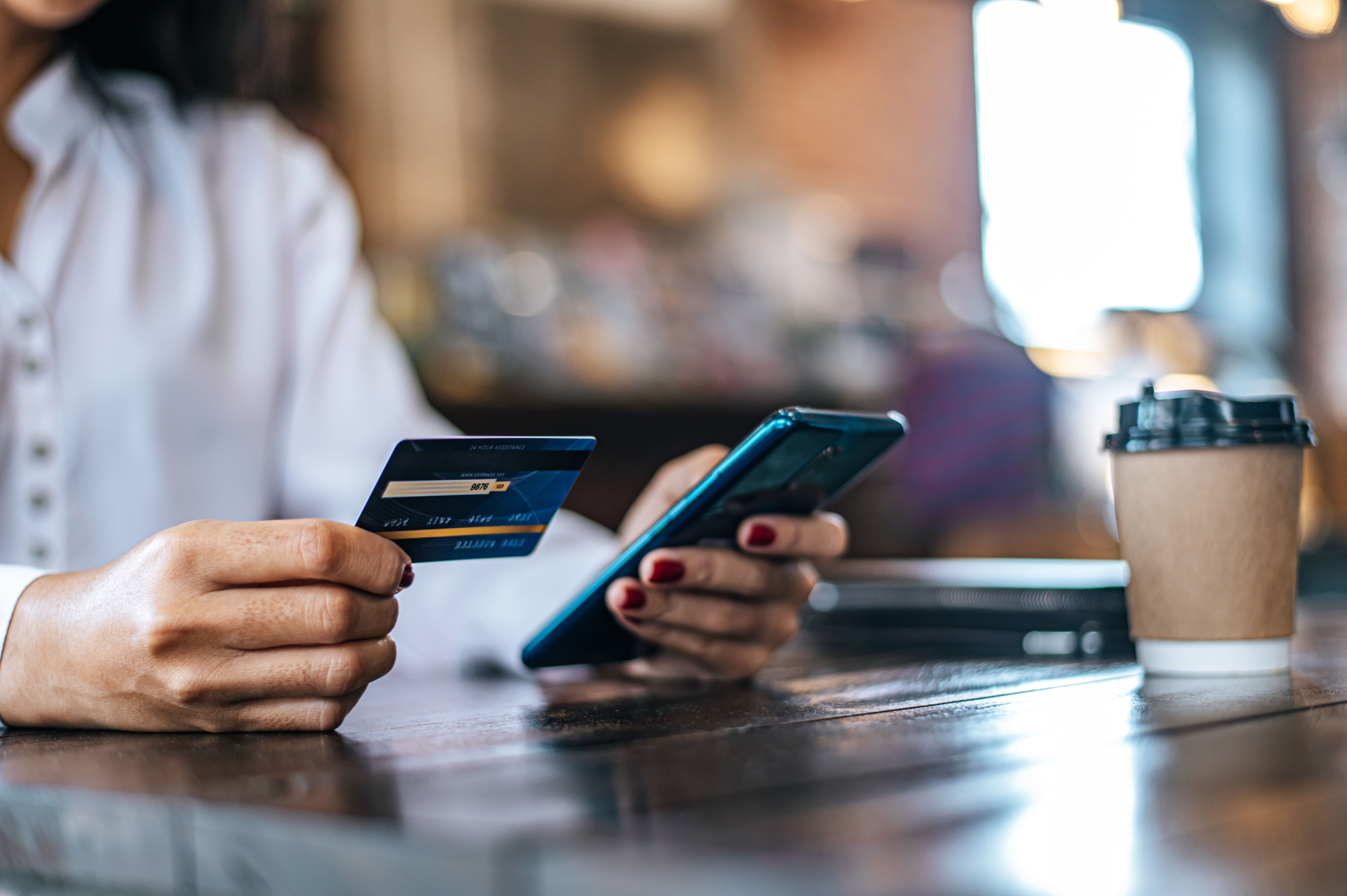 pay-goods-by-credit-card-through-smartphone-coffee-shop-min